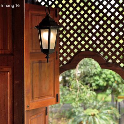 Wooden trellis adorn the facade of the house.